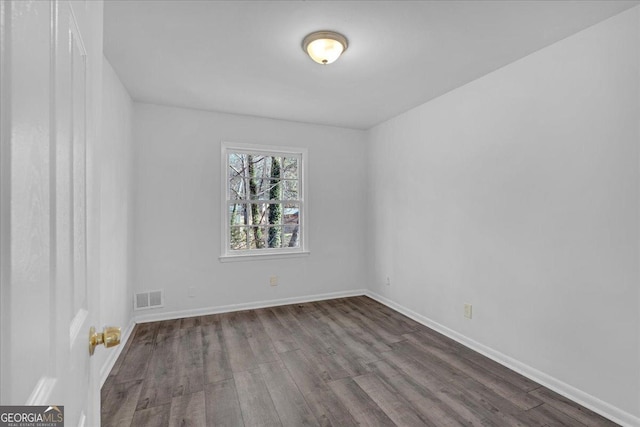 spare room with hardwood / wood-style flooring