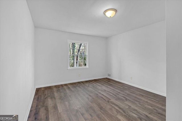 unfurnished room with dark hardwood / wood-style floors