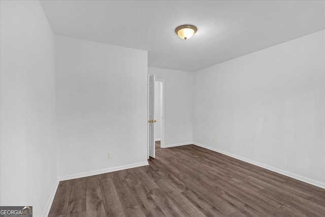 unfurnished room featuring dark wood-type flooring