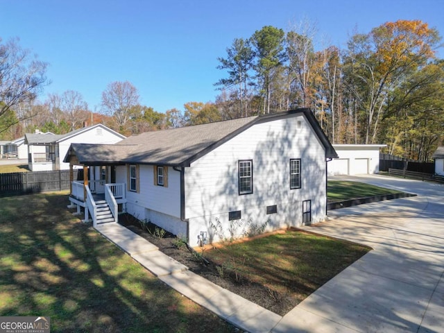 view of front of home with a front lawn, an outdoor structure, and a garage