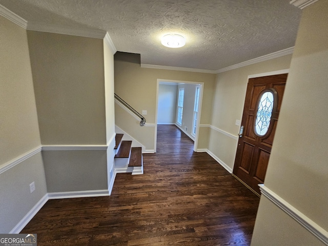 entrance foyer featuring dark hardwood / wood-style floors, crown molding, and a textured ceiling