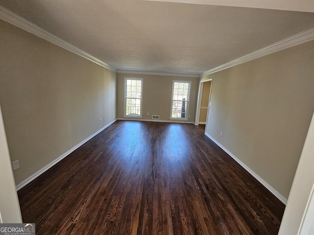 empty room featuring dark hardwood / wood-style floors and ornamental molding