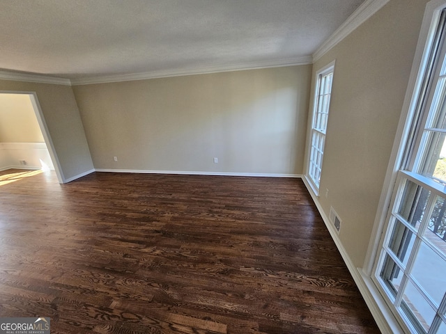 unfurnished room with crown molding, dark wood-type flooring, and a textured ceiling