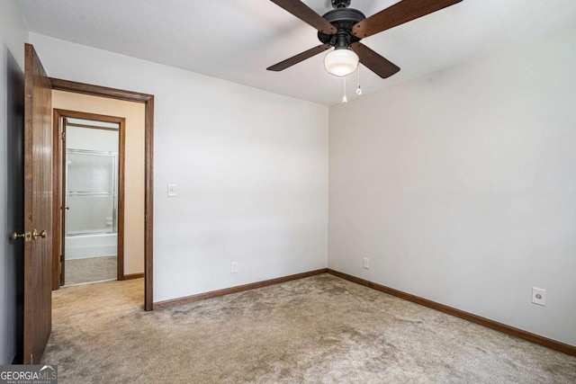 carpeted spare room featuring ceiling fan