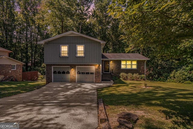 tri-level home with a garage and a front lawn