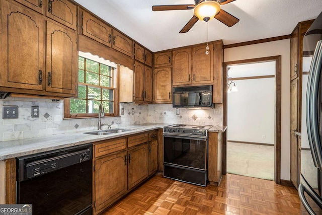 kitchen with decorative backsplash, ceiling fan, crown molding, sink, and black appliances