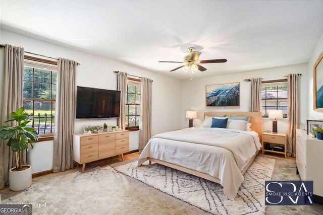 bedroom with multiple windows and ceiling fan