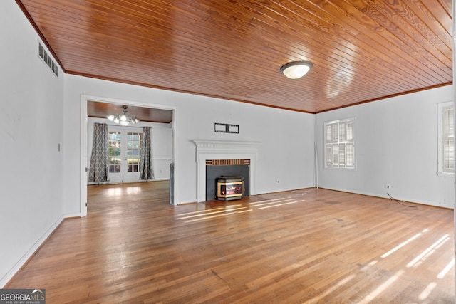 unfurnished living room with hardwood / wood-style flooring, wood ceiling, ornamental molding, and french doors