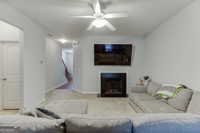 carpeted living room with ceiling fan