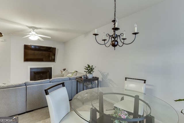 dining room with ceiling fan with notable chandelier