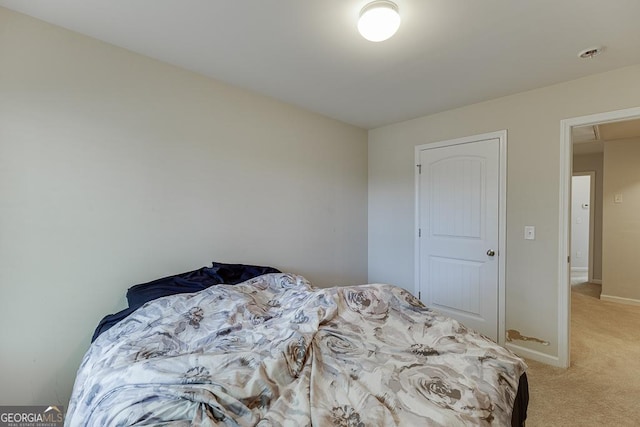 bedroom featuring light carpet