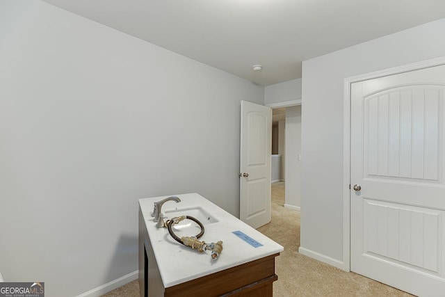 interior space with light colored carpet and sink