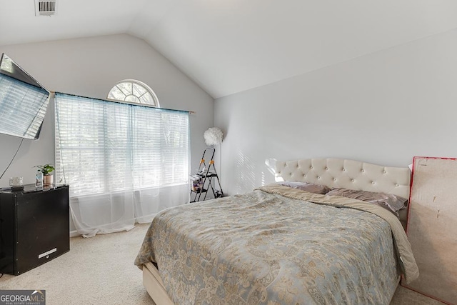 carpeted bedroom with lofted ceiling