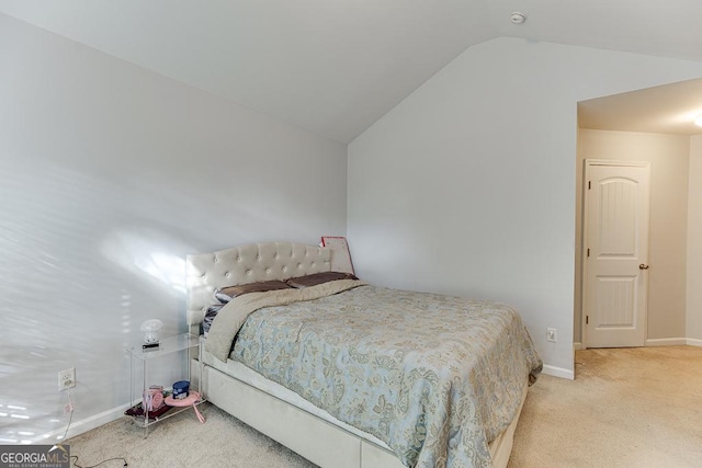 carpeted bedroom featuring vaulted ceiling