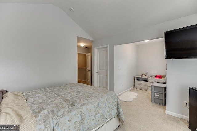 bedroom with light colored carpet and lofted ceiling