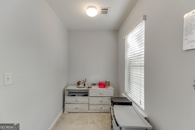 office area featuring light carpet