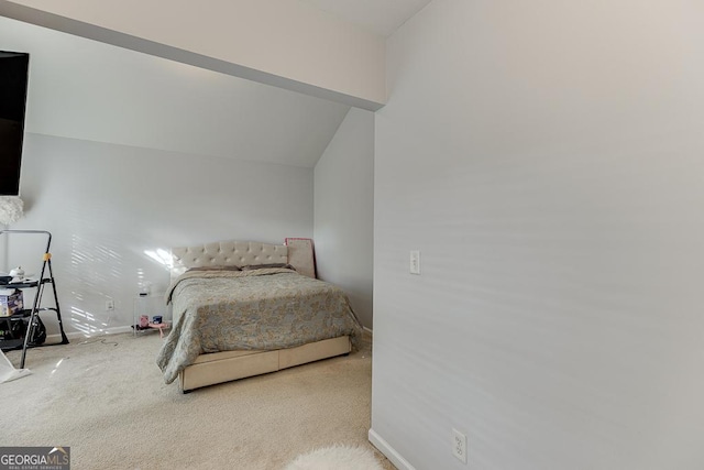 carpeted bedroom with vaulted ceiling