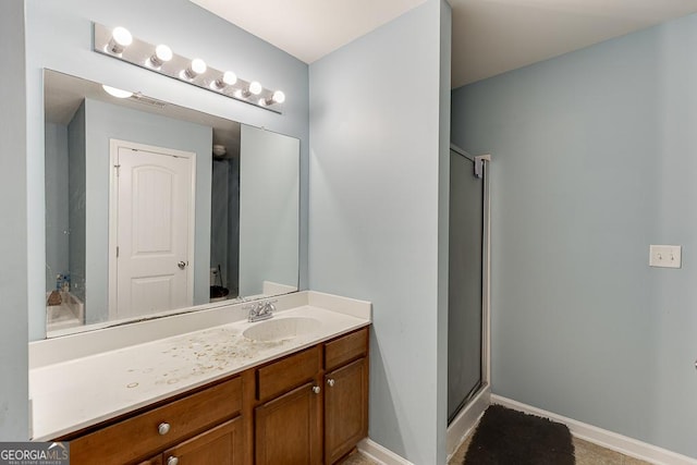 bathroom featuring vanity and a shower with door