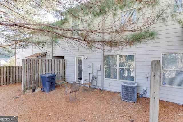 back of house with central air condition unit