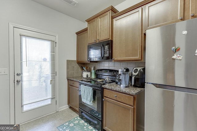 kitchen with stone counters, tasteful backsplash, and black appliances