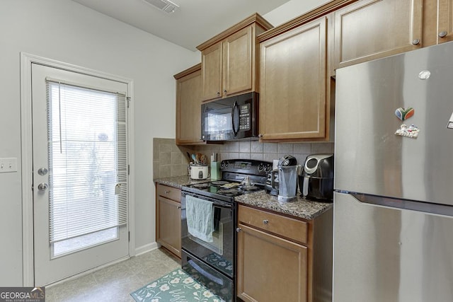 510 Jefferson Chase St, Atlanta, GA 30354 - kitchen with visible vents, dark stone countertops, decorative backsplash, and black appliances