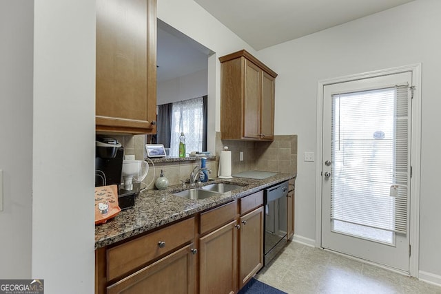 kitchen with dishwasher, tasteful backsplash, plenty of natural light, and dark stone counters