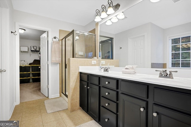 bathroom with tile patterned flooring, vanity, and an enclosed shower