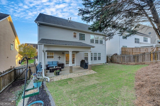 back of house with outdoor lounge area, a yard, and a patio