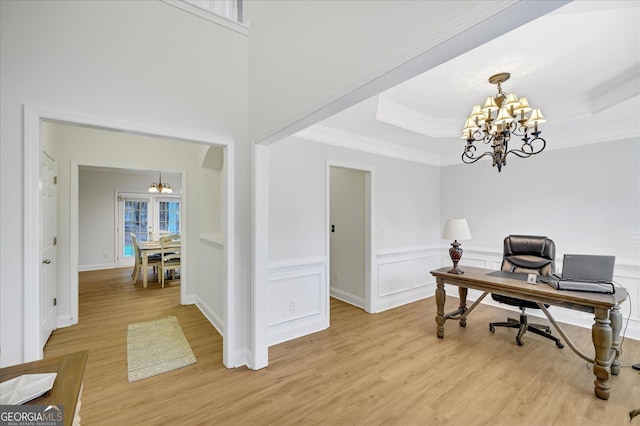 office with french doors, light wood-type flooring, an inviting chandelier, and ornamental molding