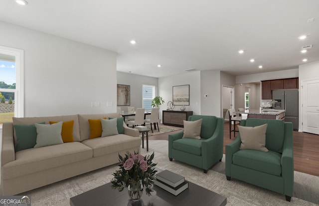 living room with light hardwood / wood-style floors and a healthy amount of sunlight