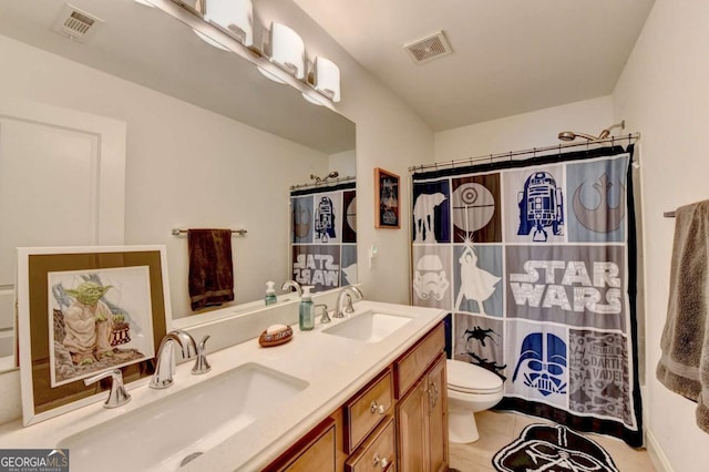 bathroom featuring a shower with shower curtain, vanity, toilet, and tile patterned floors