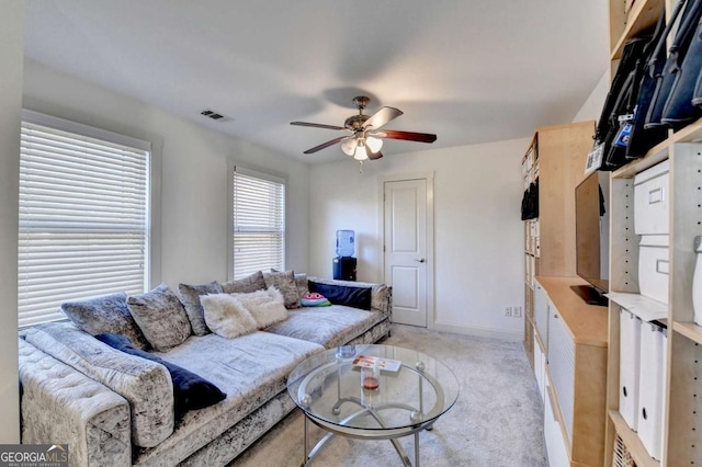 living room with ceiling fan and light colored carpet