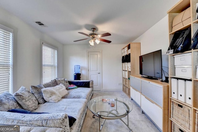 carpeted living room featuring ceiling fan