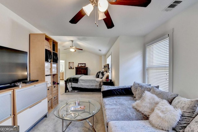 bedroom with ceiling fan, lofted ceiling, and light carpet