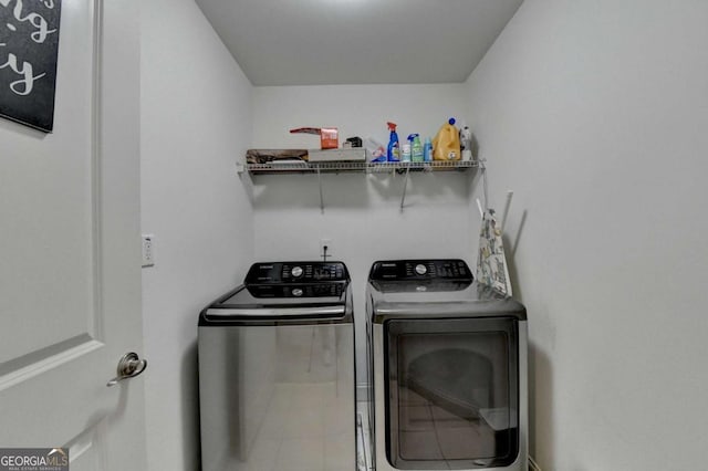 clothes washing area with separate washer and dryer