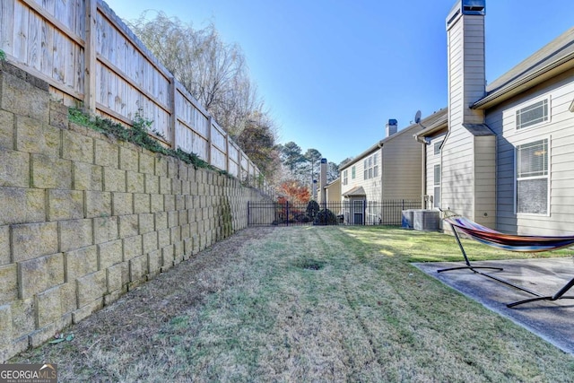 view of yard featuring a patio area and central air condition unit