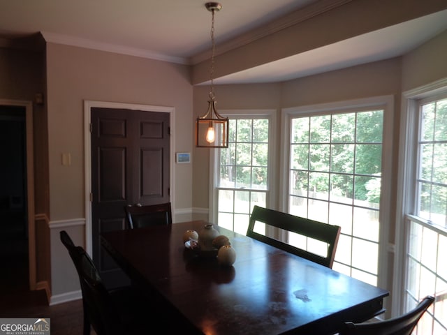 dining space featuring hardwood / wood-style flooring and ornamental molding