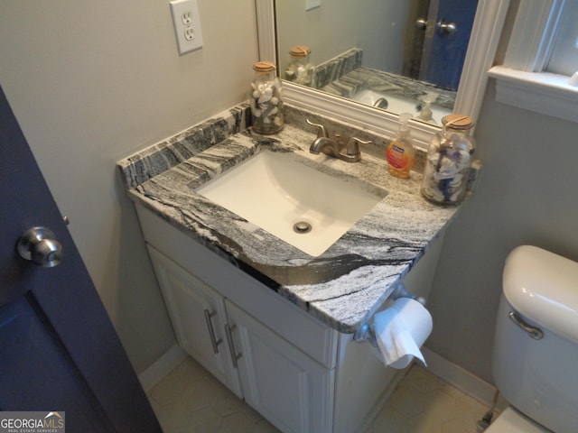 bathroom with tile patterned floors, vanity, and toilet