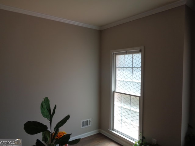 interior space featuring crown molding and wood-type flooring