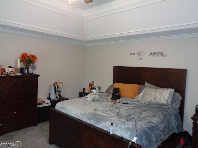 carpeted bedroom with ornamental molding