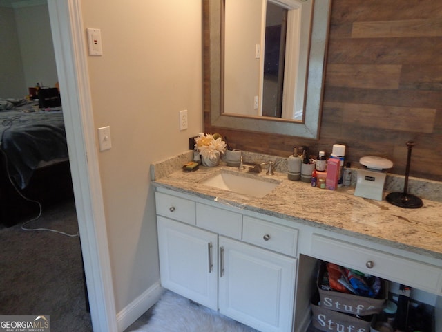 bathroom with vanity and wooden walls