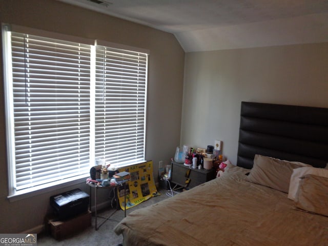 bedroom with carpet and lofted ceiling