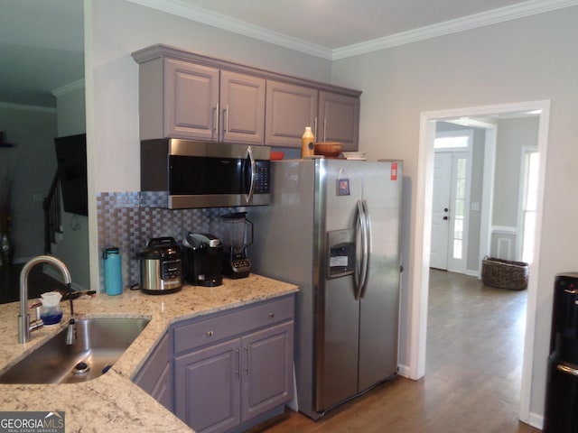 kitchen featuring gray cabinets, crown molding, sink, and stainless steel appliances