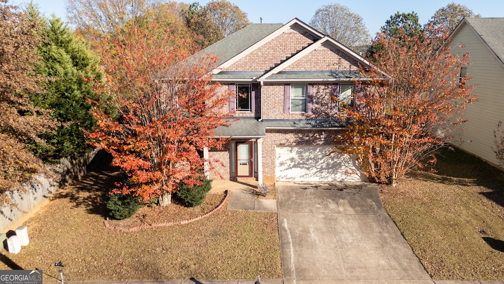 view of front of house featuring a front lawn and a garage