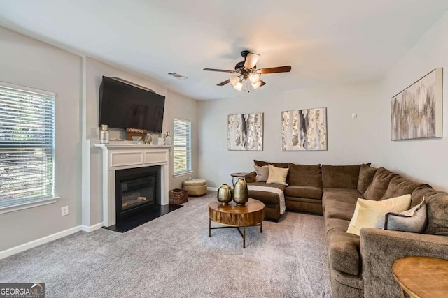 living room with ceiling fan and carpet