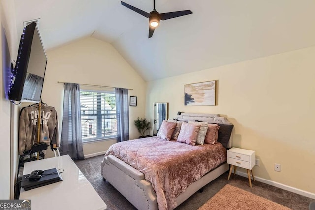 bedroom with ceiling fan, dark carpet, and lofted ceiling