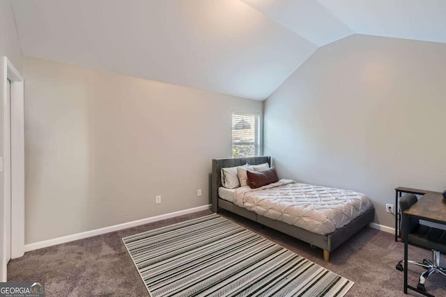 bedroom featuring dark colored carpet and vaulted ceiling