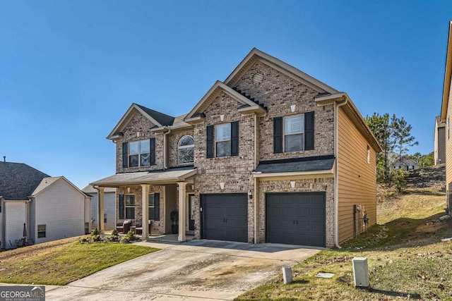 view of front of home featuring a porch, a garage, and a front lawn