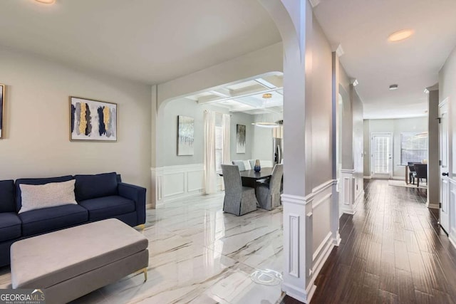 living room with beamed ceiling, hardwood / wood-style floors, and coffered ceiling