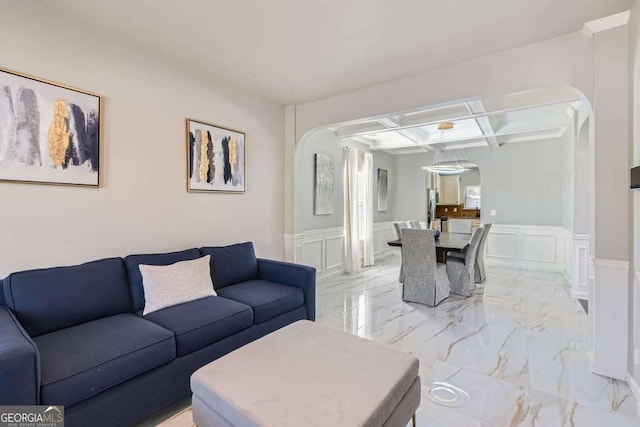 living room featuring beamed ceiling and coffered ceiling